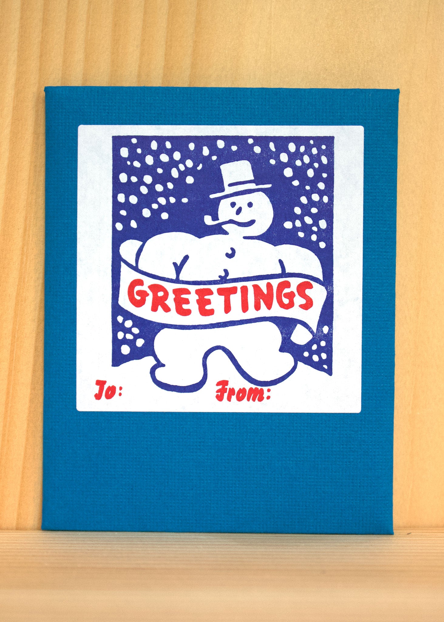 A snowman standing cheerfully in the snow, with a pipe and button eyes, symbolizing winter joy.